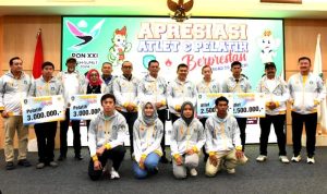 Gubernur Kepri H.Ansar Ahmad menyerahkan dana apresiasi pada Atlet dan Pelatih Kontingen PON XXI Kepri di Ballroom Hotel AP Premier Jodoh Kota Batam, Rabu (1/5/2024). (Foto: Diskominfo Kepri)