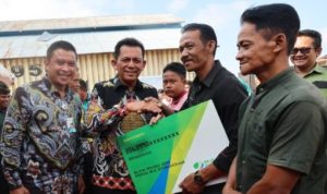 Gubernur Kepri Ansar Ahmad, menyerahkan secara simbolis BPJS Ketenagakerjaan pada Nelayan Kepri di Bintan. Tahun ini Pemprov Kepri mengalokasikan Rp7,3 M dana iuran BPJS Ketenagakerjaan 36.500 Nelayan di Provinsi Kepri. (Foto: Diskominfo Kepri)