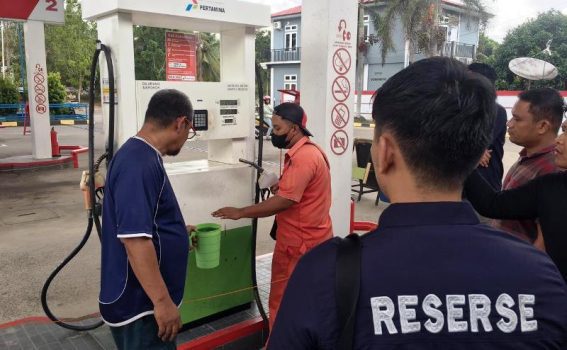 Kanit Tipiter Satreskrim Polres Bintan dan anggotanya meminta pihak pengawas dan operator SPBU milik PT Sinar Mustika Bintan mengambil pertalite bercampur solar sebagai barang bukti penyidikan. (Foto: Hasura/Presmedia.id)