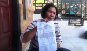Ibu korban Rubiati saat menunjukan surat laporan pengeroyokan di Rumahnya di Tanjungpinang. (Foto: Roland/Presmedia.id)